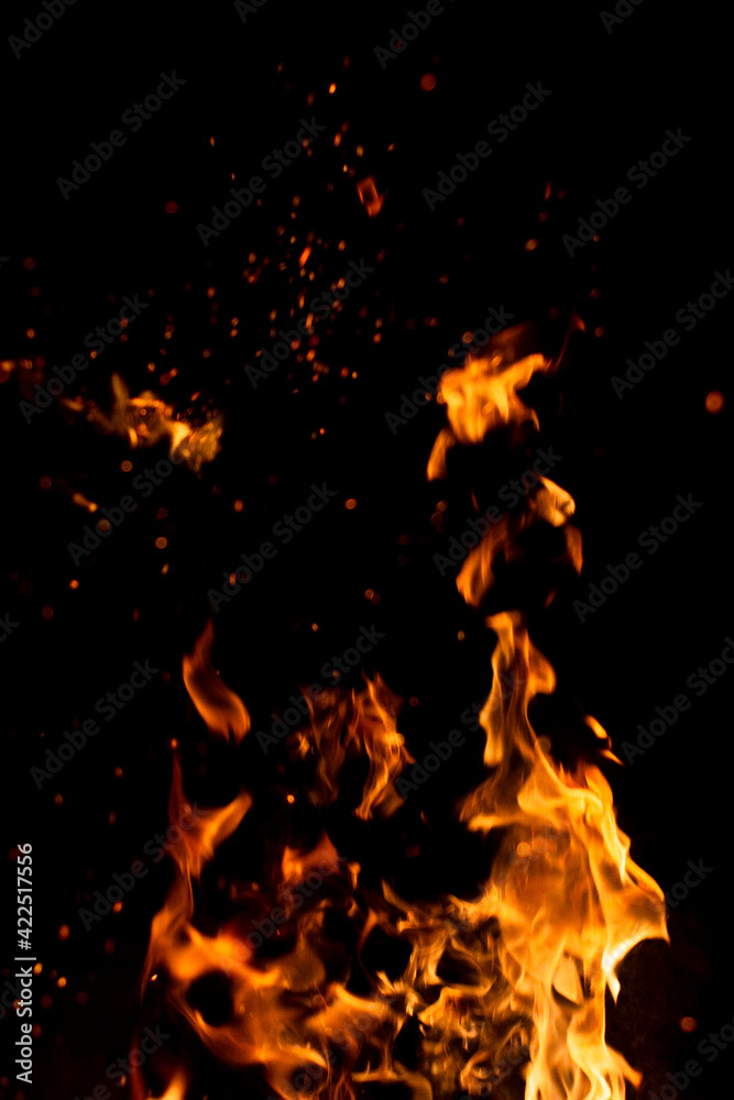 Obraz premium Big fire and silhouette of brazier on black background. Flame of fire in dark. Bonfire in barbecue at night. Dance of flame. Form of blaze