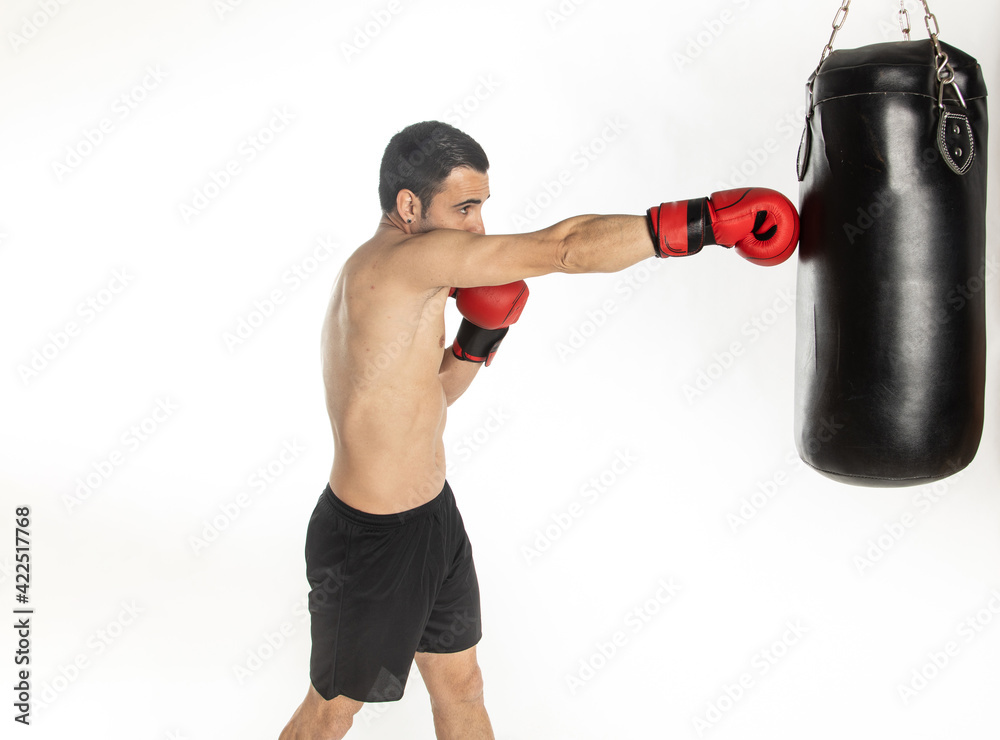 Athlete man training with boxing gloves on white background.