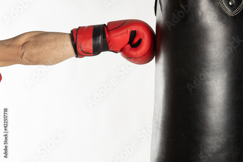 Athlete man training with boxing gloves on white background. © robcartorres