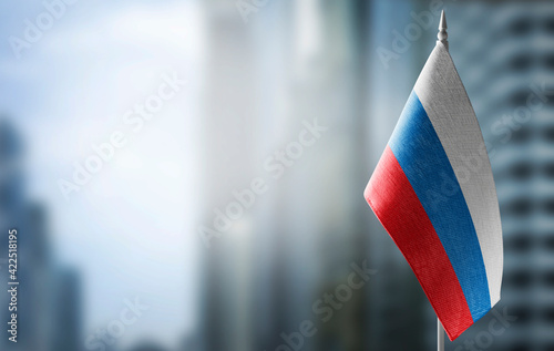 A small flag of Russia on the background of a blurred background