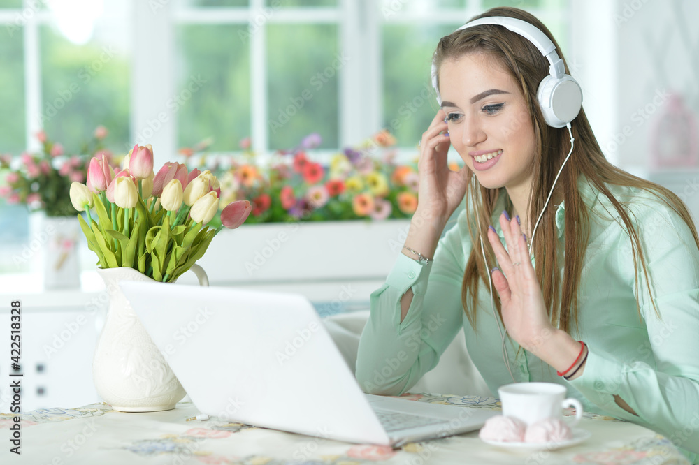 Portrait of businesswoman in headphones working in office with laptop Portrait of businesswoman in headphones working in office with laptop