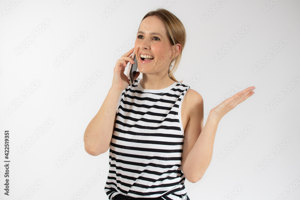 Young beautiful smiling woman talking on mobile phone isolated over white background. Young beautiful smiling woman talking on mobile phone isolated over white background.