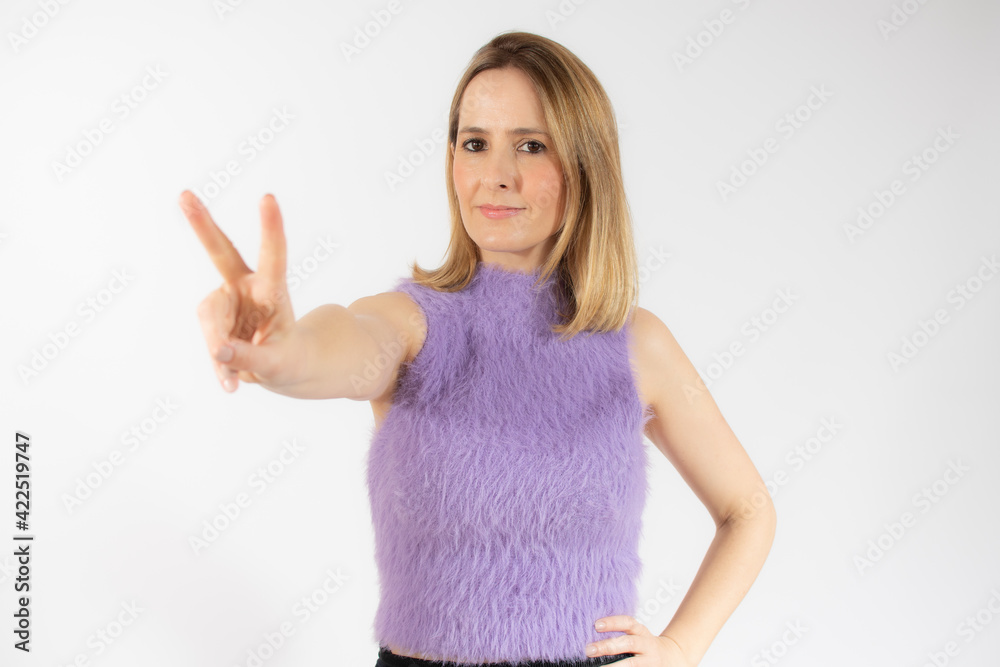 Young woman over isolated background smiling and showing victory sign Young woman over isolated background smiling and showing victory sign