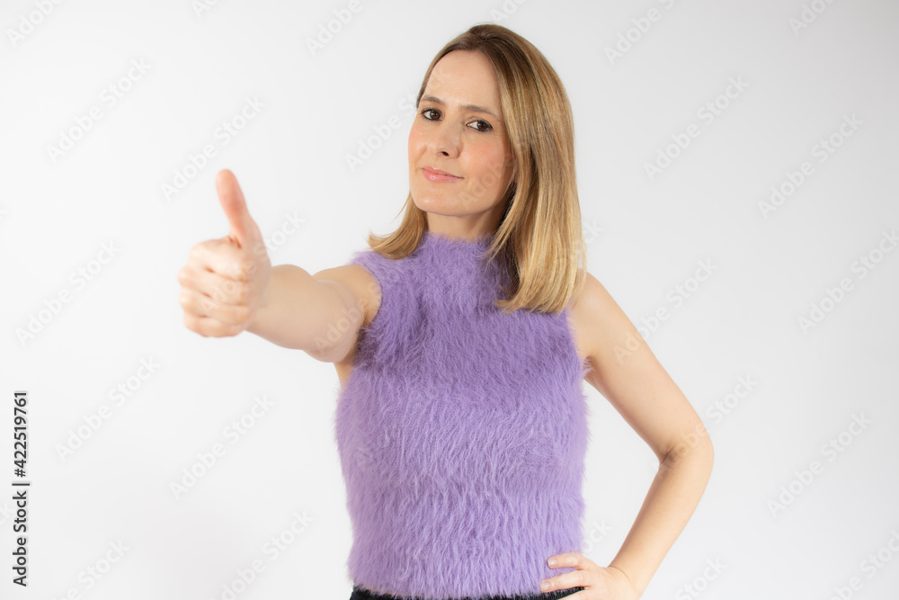 Portrait of smiling pretty young woman showing thumb up isolated over white background
