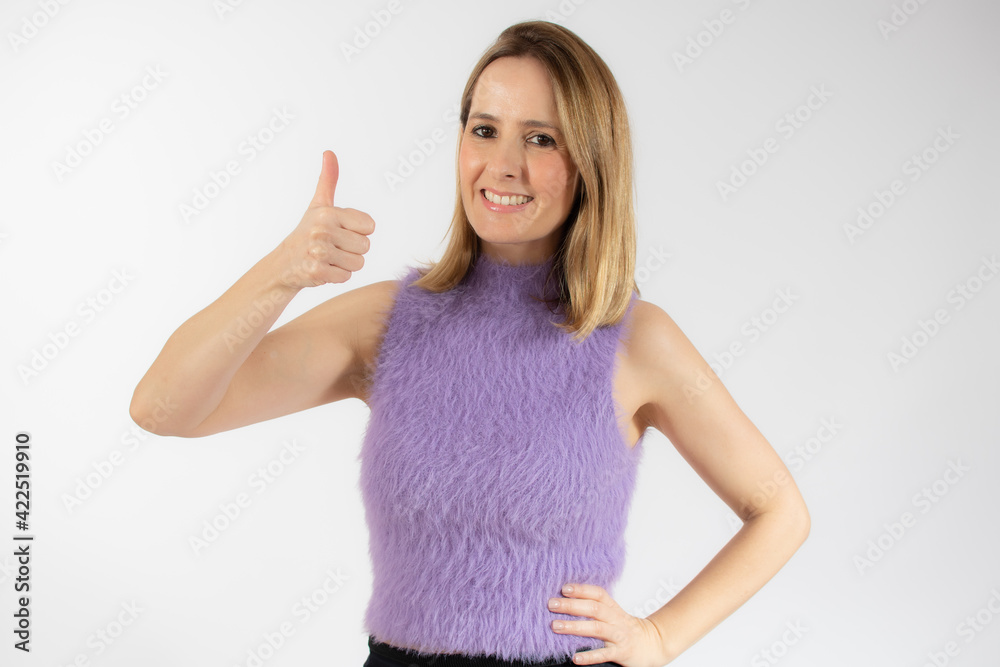 Portrait of smiling pretty young woman showing thumb up isolated over white background Portrait of smiling pretty young woman showing thumb up isolated over white background