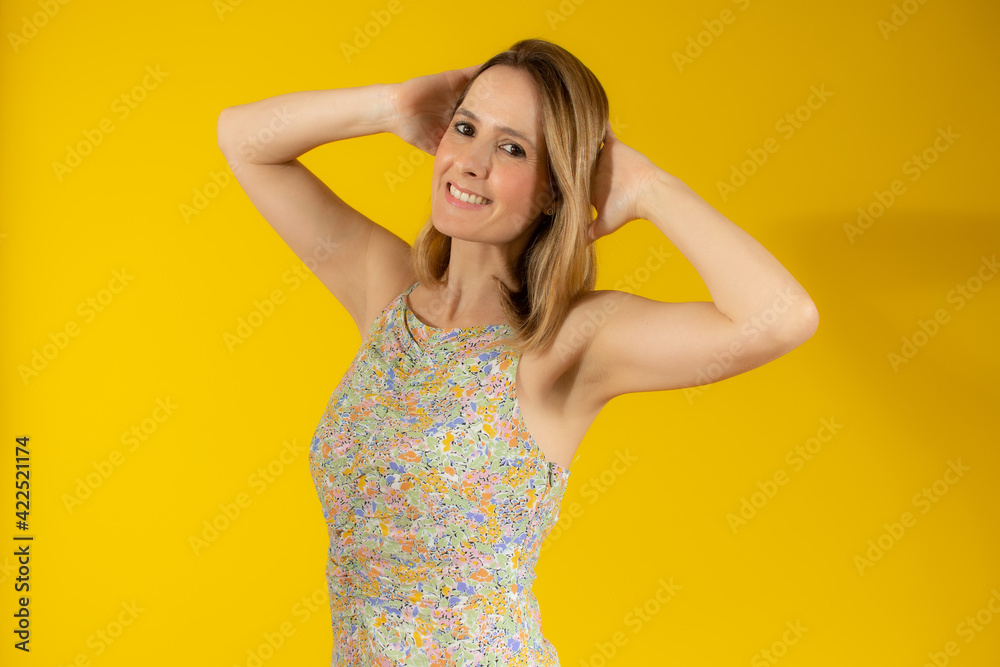 Portrait of happy young woman in summer dress isolated over yellow background. Portrait of happy young woman in summer dress isolated over yellow background.