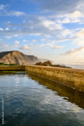 Water of a source seen from close to the background cliffs, Selective Focus photo