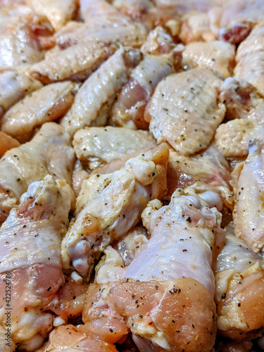 raw chicken wings marinated ad ready for cooking