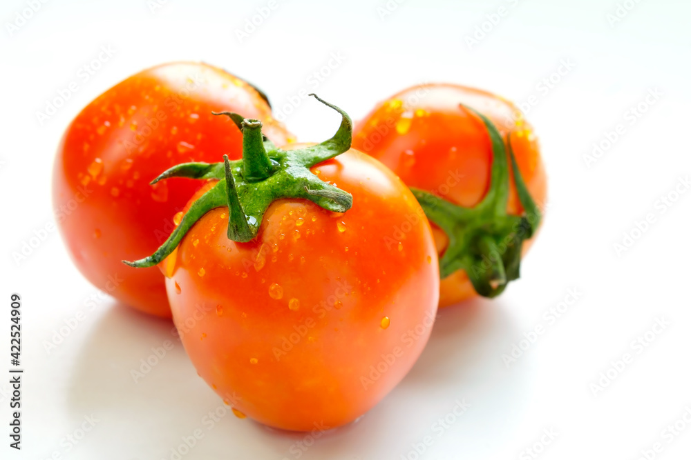 Fresh tomatoes on white wooden table in sunlight. Fresh tomatoes on white wooden table in sunlight.