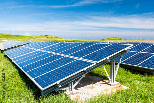 Solar cells or solar module or solar panels in solar power plant turn up skyward absorb the sunlight from the sun use light energy to generate electricity on blue sky photo