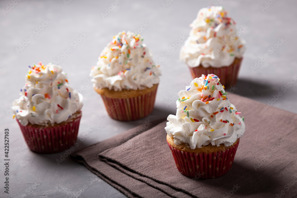 Tasty party cupcakes on the table. Cupcakes with whipped cream. Tasty party cupcakes on the table. Cupcakes with whipped cream.