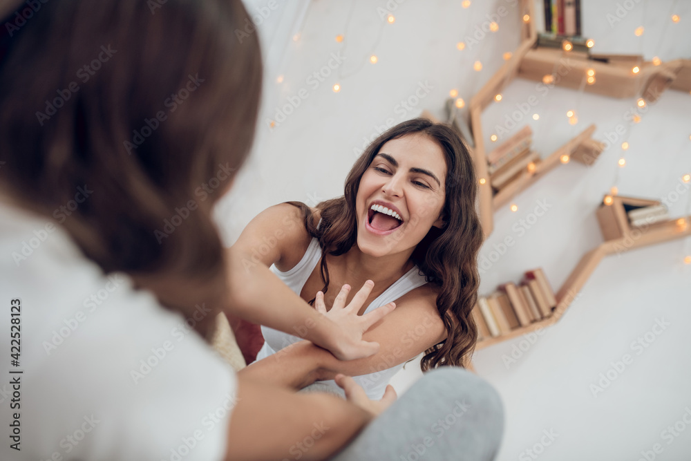 Obraz premium Woman and girl having fun playing at home