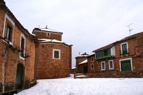 square, stone church and houses in a village in spain © frdric