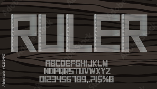 Plastic ruler alphabet texture with numbers isolated on dark background. 