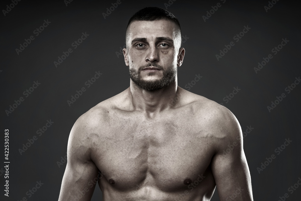 Fototapeta premium Bruised fighter on gray background