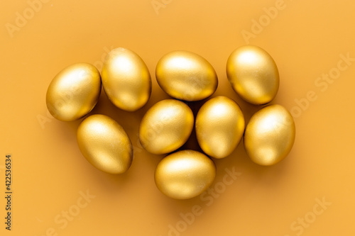 Golden eggs flat lay. Save money. Wealth and good luck symbol