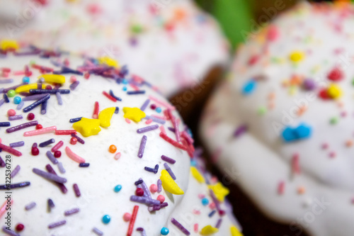 Sugar icing decoration on easter spring holidays sweet bread, paska composition close-up with blurred background. Orthodox traditional handmade kulich with topping