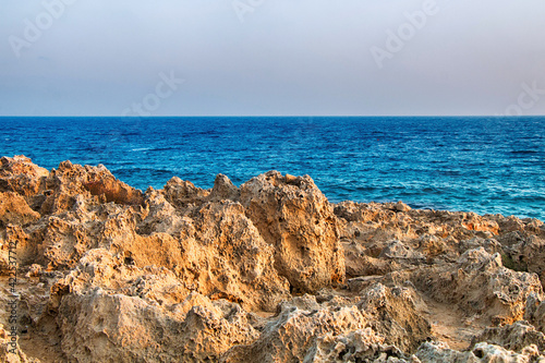 Beautiful mountain rocks against the background of the blue sea. Summer landscape