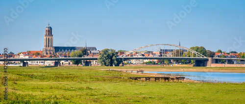 Dutch panorama landschape near the Hanze city of Deventer. The famous Wilhelmina Bridge and Great Church or St. Lebuinus Church can also be seen. It is a warm and clear summer September day. photo