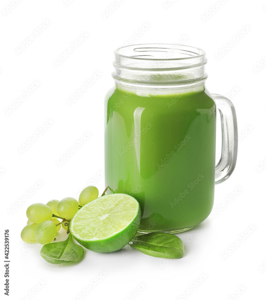 Mason jar of healthy green smoothie and ingredients on white background Mason jar of healthy green smoothie and ingredients on white background