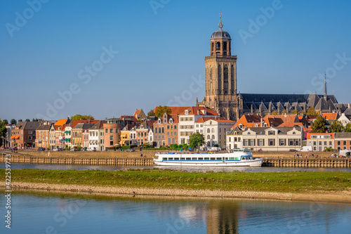 Dutch landschape near the Hanze city of Deventer. The famous Wilhelmina Bridge and the St. Nicholas Church or the Berg Church can be seen. It is a warm and clear summer September day.  photo