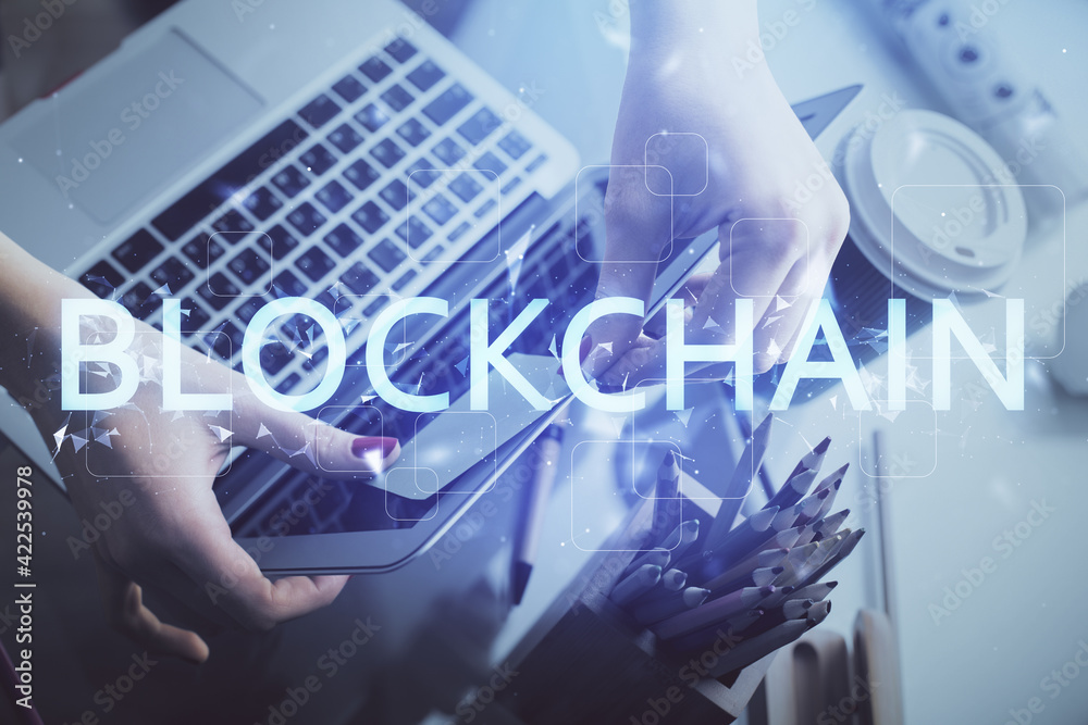 Double exposure of woman hands typing on computer and crypto market theme hologram drawing. Blockchain concept. Double exposure of woman hands typing on computer and crypto market theme hologram drawing. Blockchain concept.