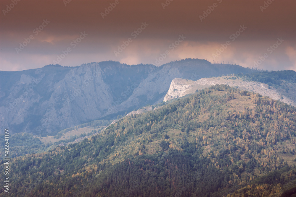 mountain, peaks and cliffs wilderness landscape with storm clouds