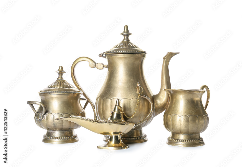 Aladdin lamp of wishes and tea set on white background Aladdin lamp of wishes and tea set on white background