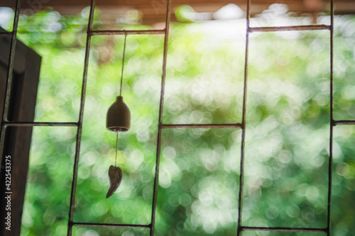 Abstract blurred Window bell Blurry  with green leaves background by defocused effect. use for background or backdrop.  Natural background and wallpaper photo