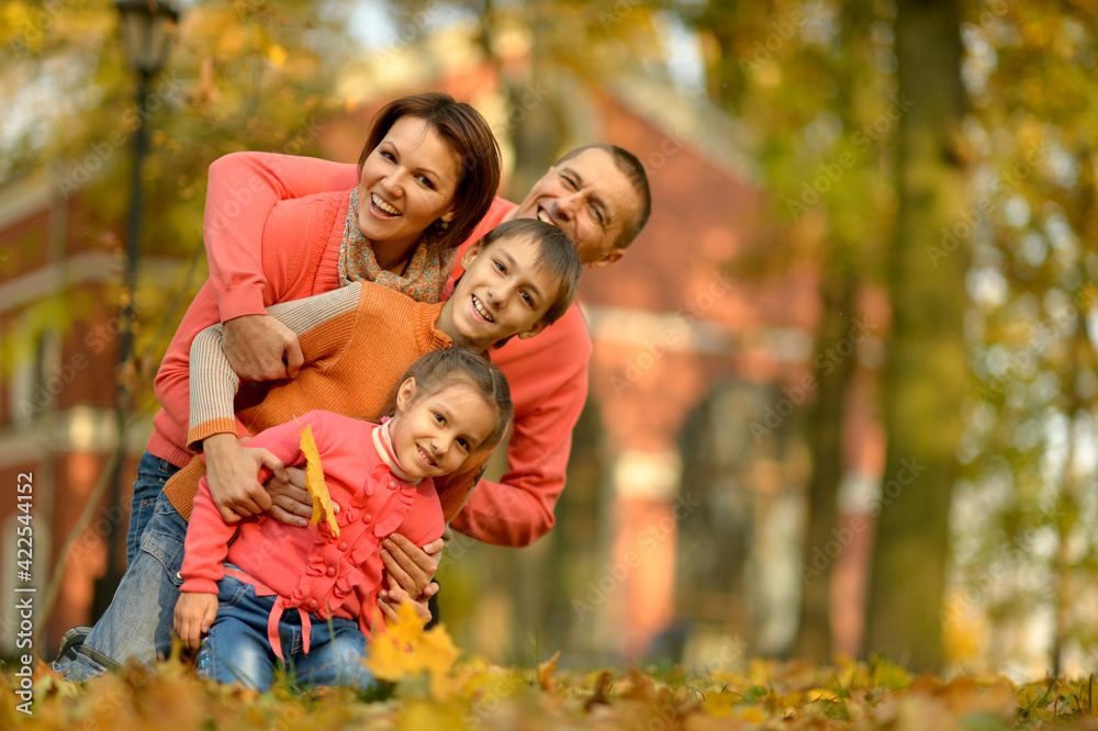 Portrait of happy young family in autumn park