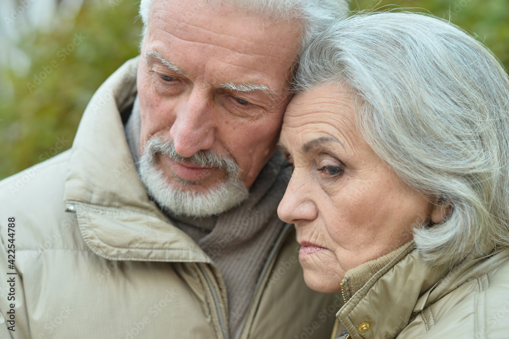 Sad thoughtful senior couple in park Sad thoughtful senior couple in park