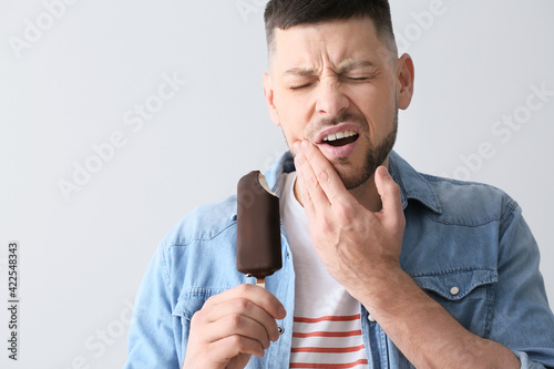 Man with sensitive teeth an...
