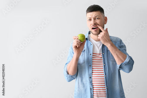Man with aching teeth and a...