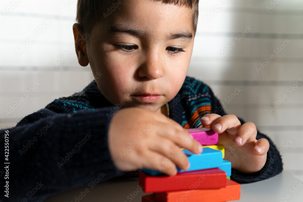 Child playing building blocks. Playing and learning at home. Building blocks. Creativity concept. Child playing building blocks. Playing and learning at home. Building blocks. Creativity concept.