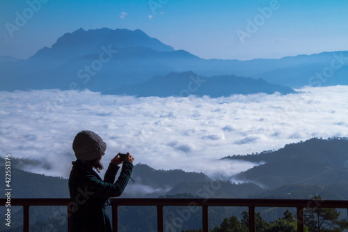 person watching sea of mist in the mountain