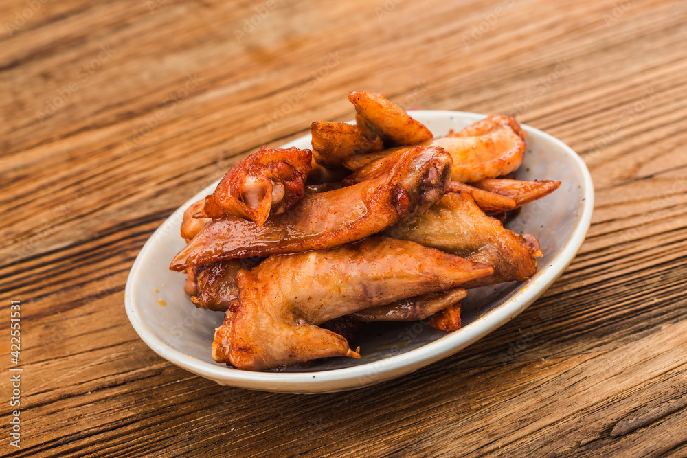A plate of freshly baked chicken wings,Chicken Wing Tip A plate of freshly baked chicken wings,Chicken Wing Tip