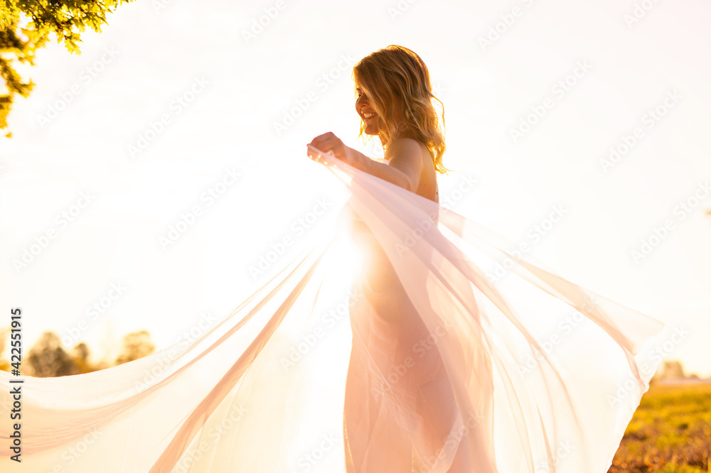 Portrait of happy woman with white cloth at sunrise Portrait of happy woman with white cloth at sunrise