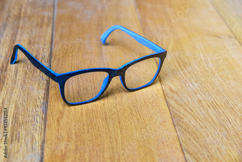 Clear eyeglasses, Glasses black and blue Frame contemporary style on wood background