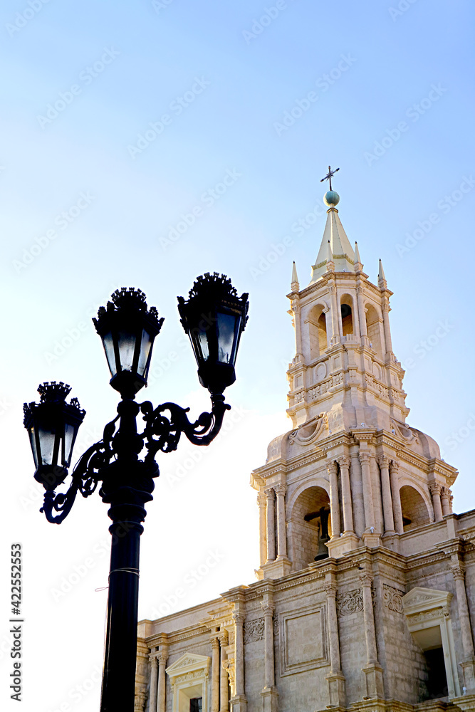 Gorgeous  White Volcanic Stone Bell Tower of Basilica Cathedral of Arequipa with Vintage Black Iron Lamppost, Arequipa, Peru