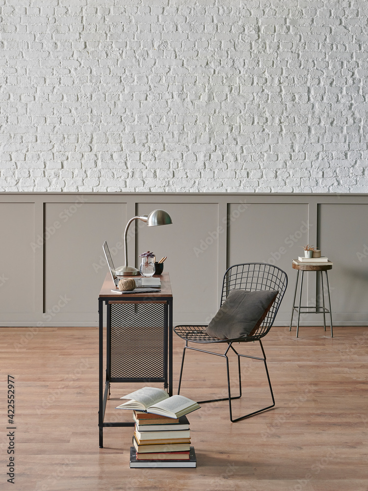 Obraz premium Working room at home style with wooden table laptop and metal black chair, poster brick wall.