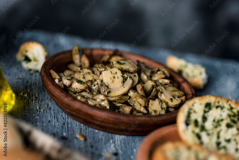 fried mushrooms with garlic and parsley in a plate fried mushrooms with garlic and parsley in a plate