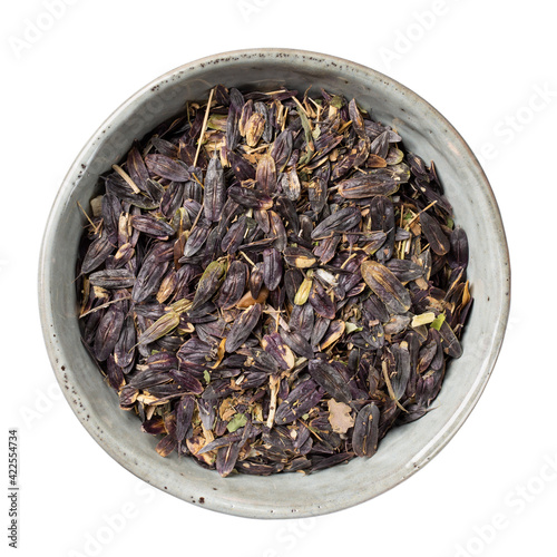 Bowl with seeds of woad (isatis tinctoria) isolated on white. Natural dye. Top view.