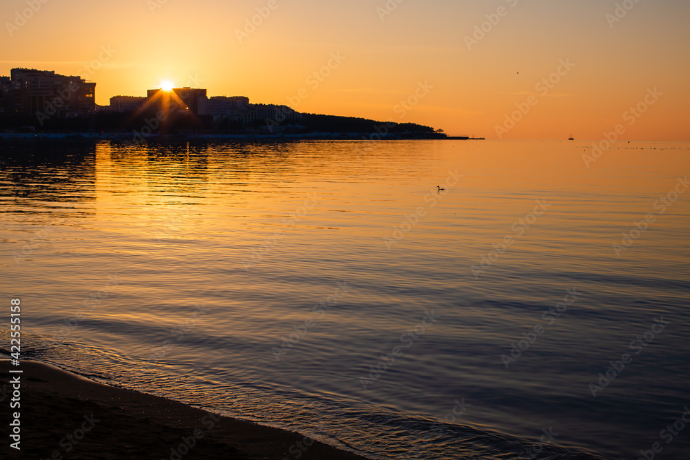 Naklejka premium Rays of the sun at sunset on the sea