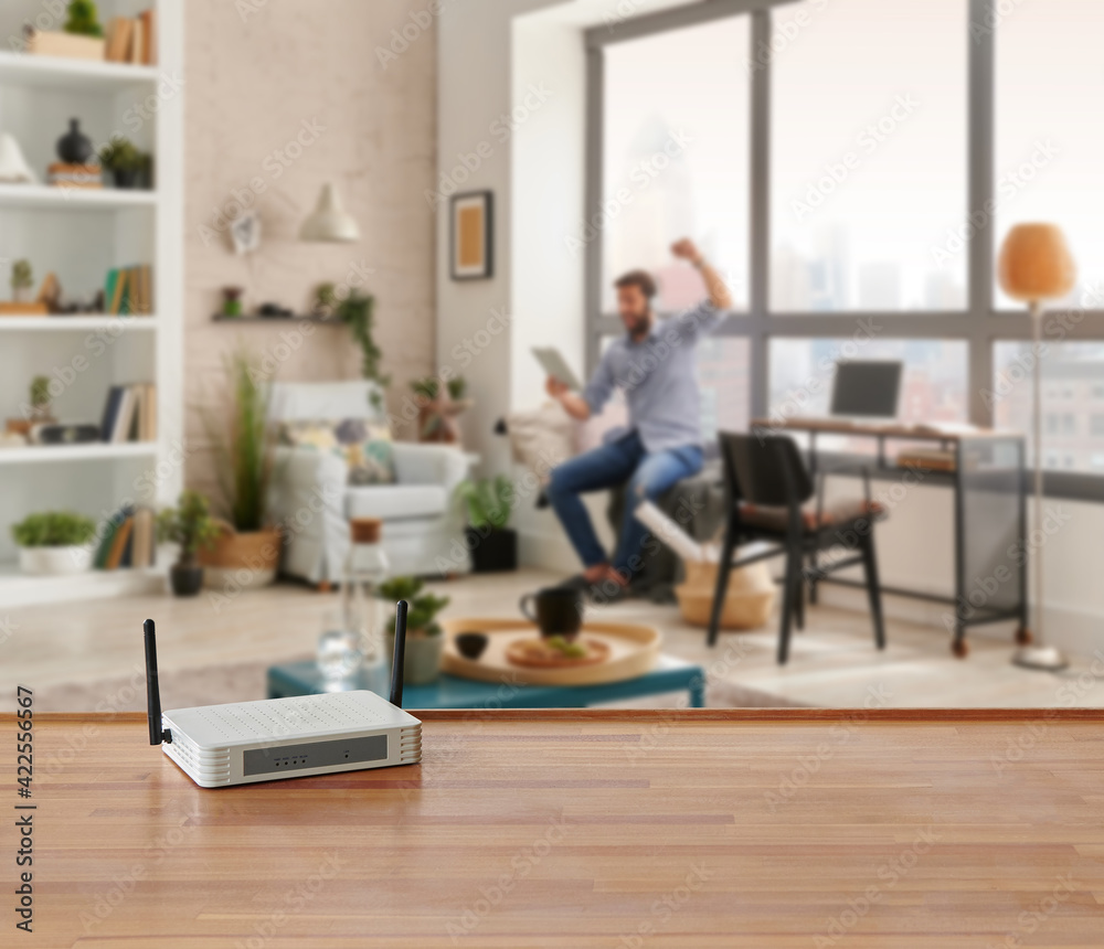 Modem and router box on the table and living room background blur concept.
