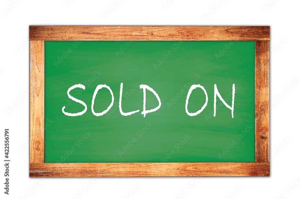 SOLD ON text written on green school board. SOLD ON text written on green school board.