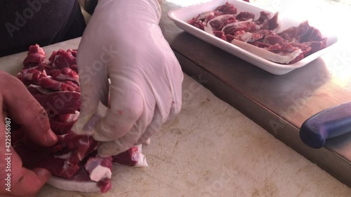A butcher cutting meat