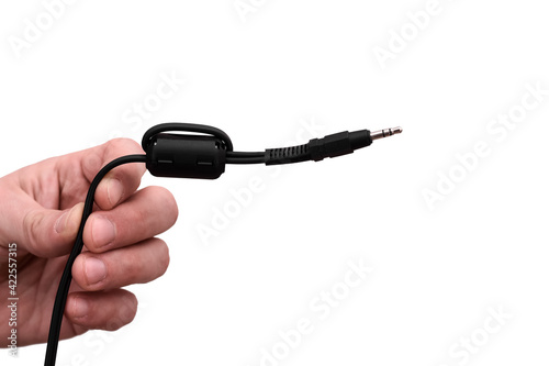 Close-up Jack plug and a cable. in the hands of a man isolated on the white background. TRS connector mini-jack 3,5mm photo