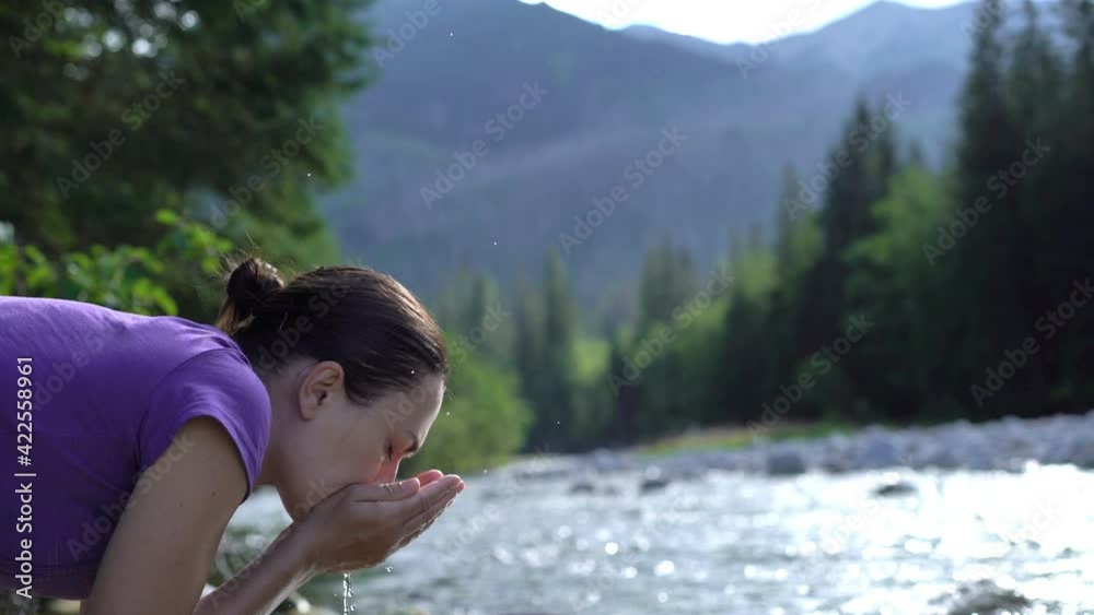 Young hiker woman drinking stream water in the mountains, Slovakia, High Tatras, Bielovodska valley
Young hiker woman drinking stream water in the mountains, Slovakia, High Tatras, Bielovodska valley