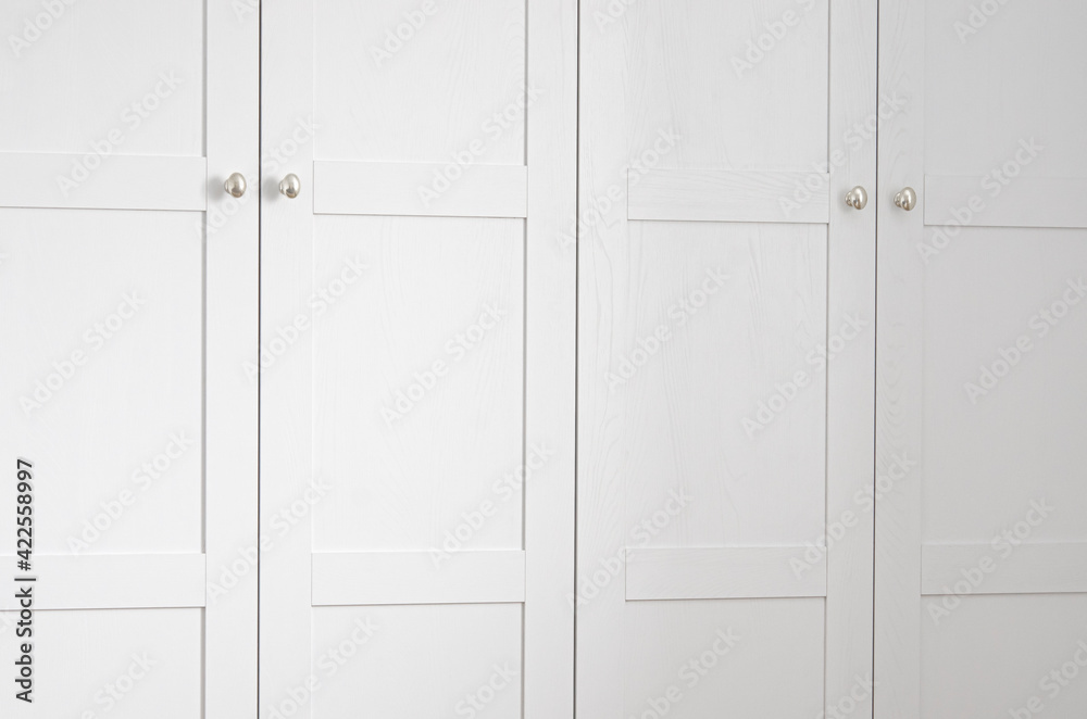 White wood facade of a Scandinavian-style closet. Interier White wood facade of a Scandinavian-style closet. Interier