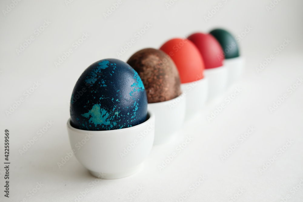 Easter eggs on porcelain stands on a white background Easter eggs on porcelain stands on a white background